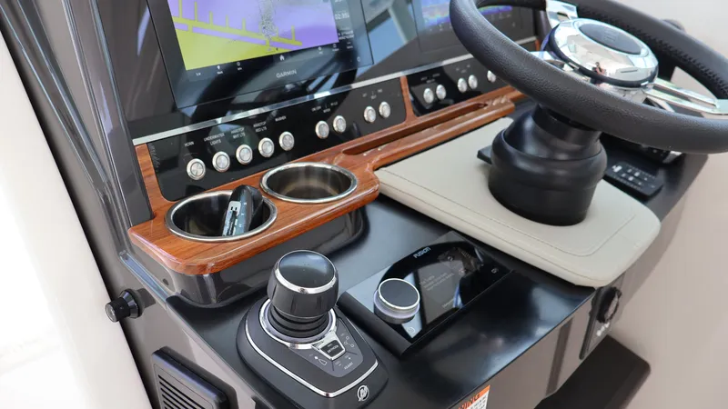 Slide: The Image of 2022 Tiara Yachts 34 LX helm with modern controls and navigation display. - 34