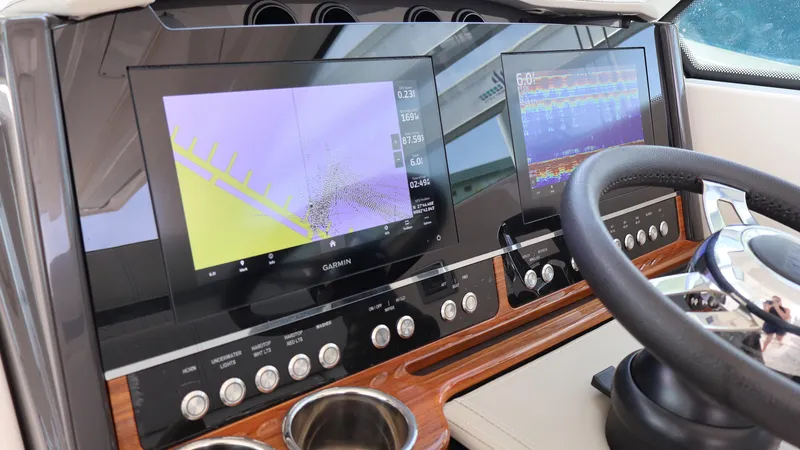 Slide: The Image of 2022 Tiara Yachts 34 LX dashboard with navigation screens and steering wheel. - 36