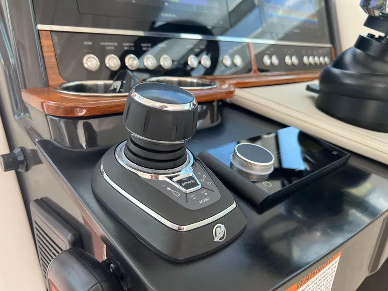 Slide: The Image of Control panel of 2022 Tiara Yachts 34 LX, featuring advanced joystick and navigation controls. - 37