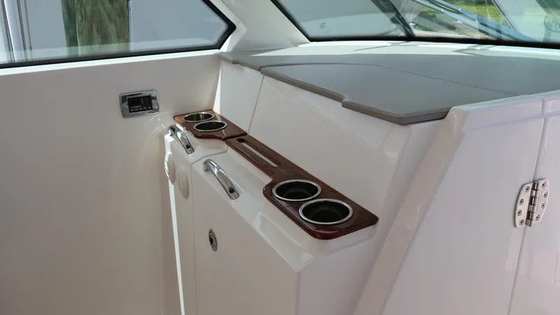 Slide: The Image of 2022 Tiara Yachts 34 LX interior with cup holders and storage compartment. - 45