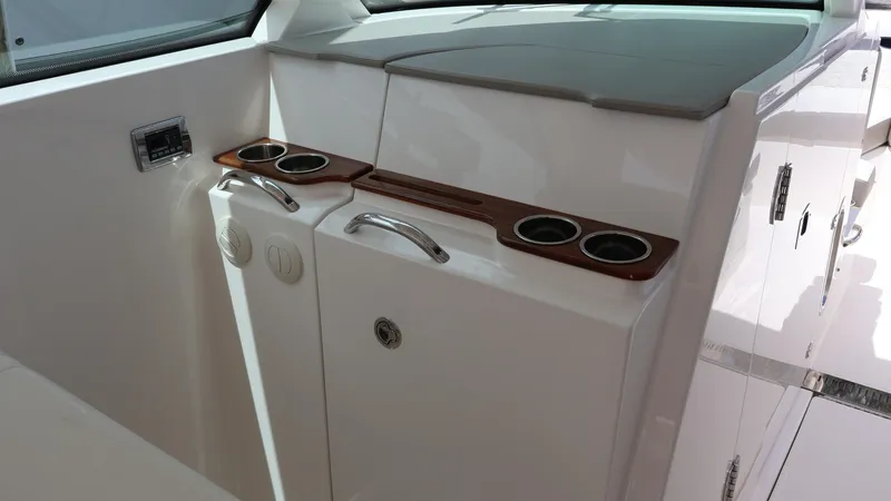 Slide: The Image of 2022 Tiara Yachts 34 LX interior with cup holders and storage compartments. - 46