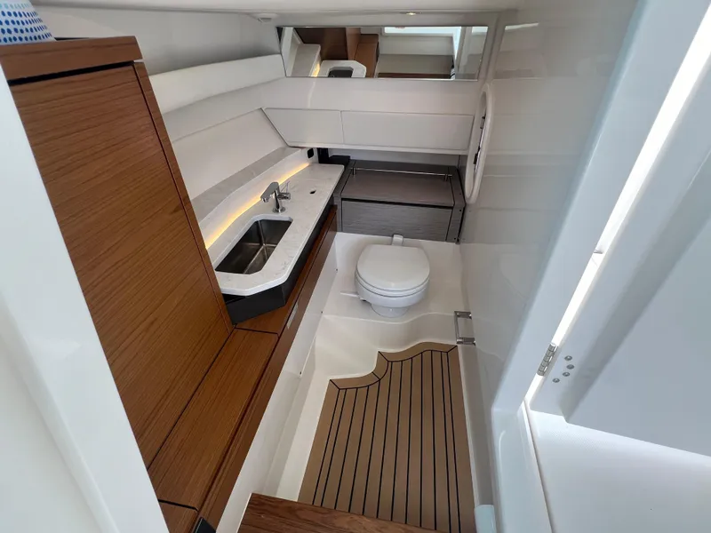 Slide: The Image of 2022 Tiara Yachts 34 LX interior with modern bathroom and wooden accents. - 47