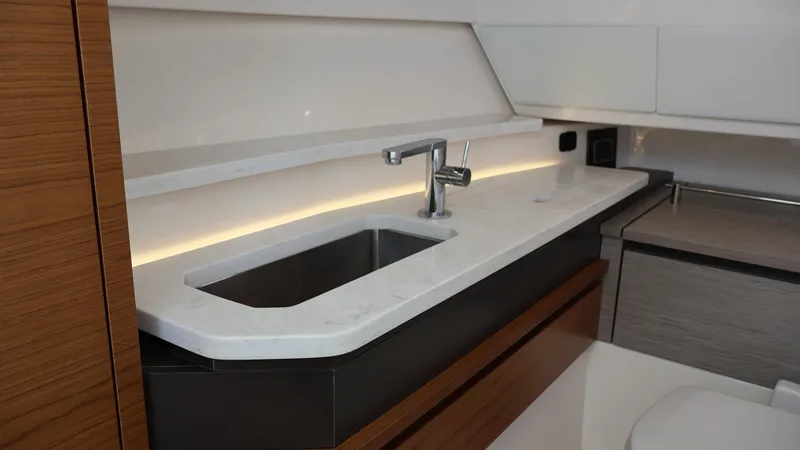 Slide: The Image of Modern kitchenette in 2022 Tiara Yachts 34 LX, featuring sleek sink and countertop design. - 48