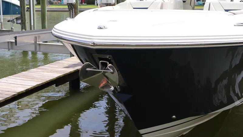 Slide: The Image of 2022 Tiara Yachts 34 LX docked, showcasing sleek bow design and anchor. - 8