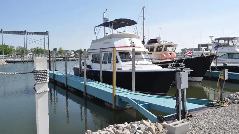 Slide: The Image of 1998 Sabre 36 Fast Trawler docked at marina, sunny day, calm waters. - 1