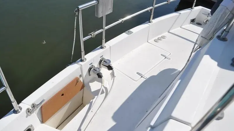 Slide: The Image of 1998 Sabre 36 Fast Trawler deck with railing and clean white surface. - 10