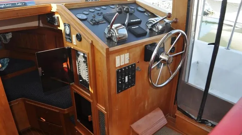 Slide: The Image of 1998 Sabre 36 Fast Trawler helm with wooden interior and navigation controls. - 11