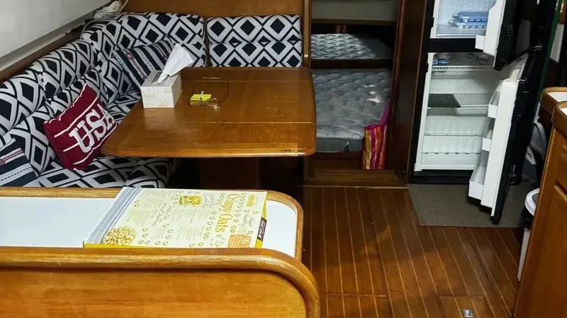 Slide: The Image of Interior of 1998 Sabre 36 Fast Trawler with wooden flooring and patterned seating. - 13