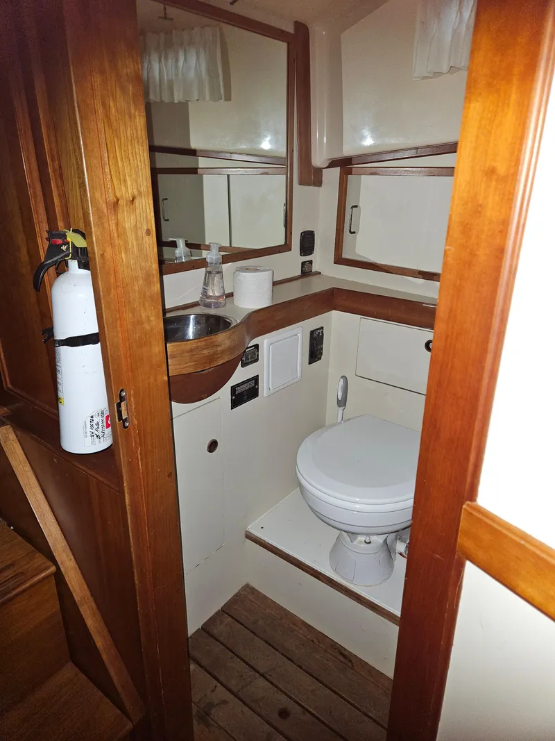 Slide: The Image of 1998 Sabre 36 Fast Trawler bathroom with wooden accents and compact design. - 18