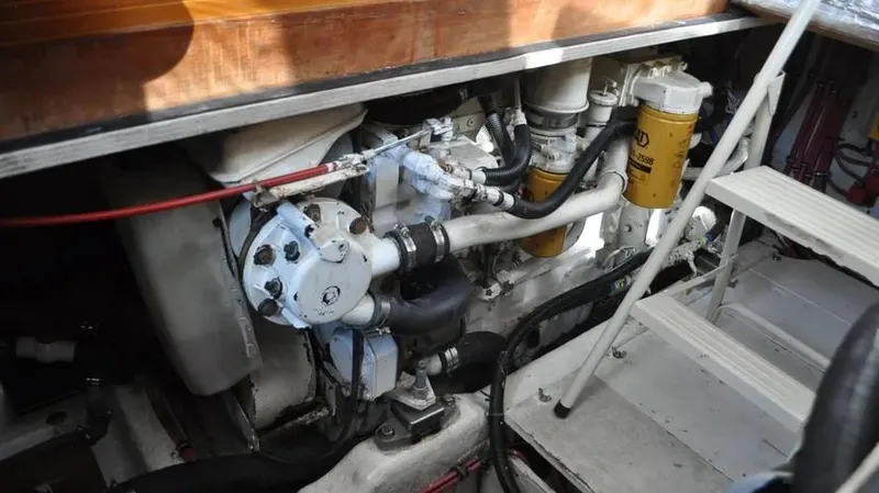 Slide: The Image of Engine compartment of 1998 Sabre 36 Fast Trawler, showcasing mechanical components and filters. - 19