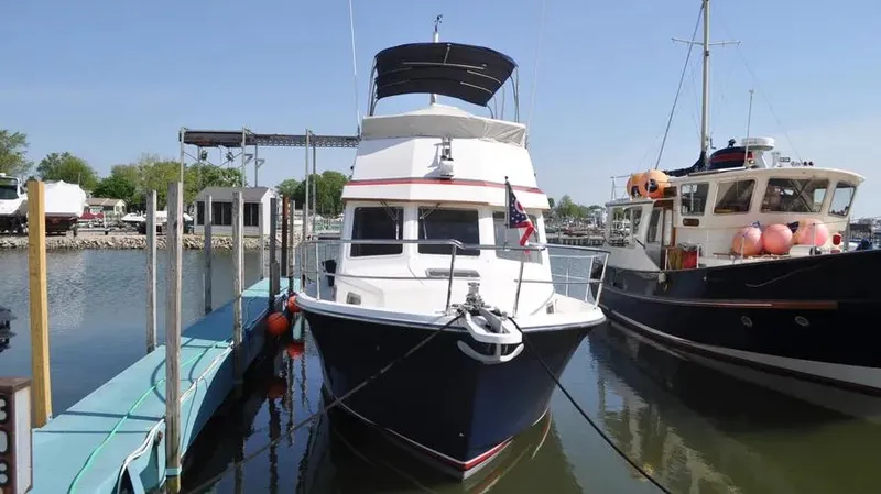 Slide: The Image of 1998 Sabre 36 Fast Trawler docked at marina, front view. - 2