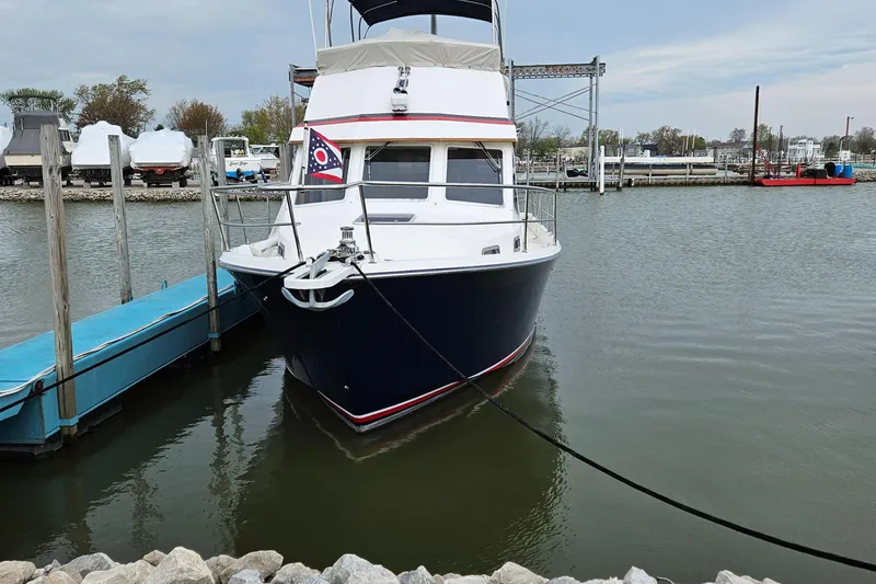 Slide: The Image of 1998 Sabre 36 Fast Trawler docked at marina, front view. - 4