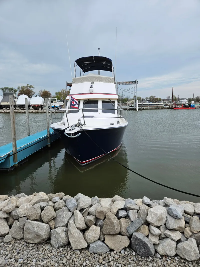 Slide: The Image of 1998 Sabre 36 Fast Trawler docked at a marina, front view. - 6