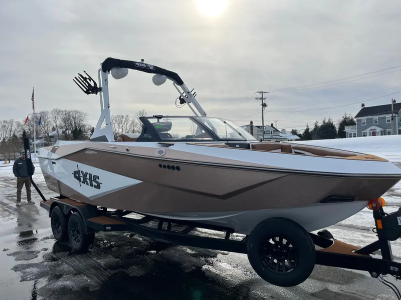 Slide: The Image of 2025 Axis T220 boat on trailer, parked outdoors on a cloudy day. - 10