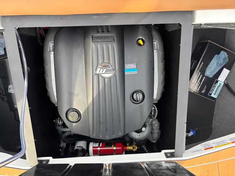 Slide: The Image of Engine compartment of a 2025 Axis T220 boat, featuring a well-maintained motor. - 13