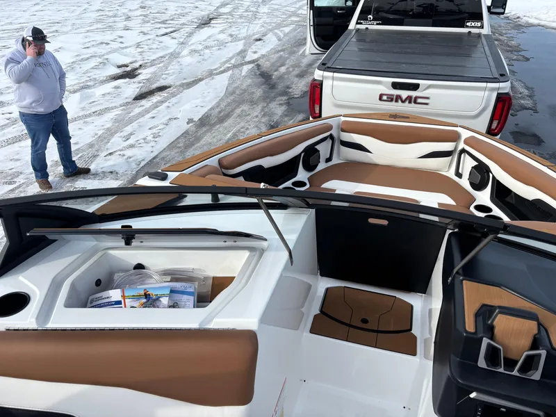 Slide: The Image of 2025 Axis T220 boat on snowy ground, near a GMC truck. - 14