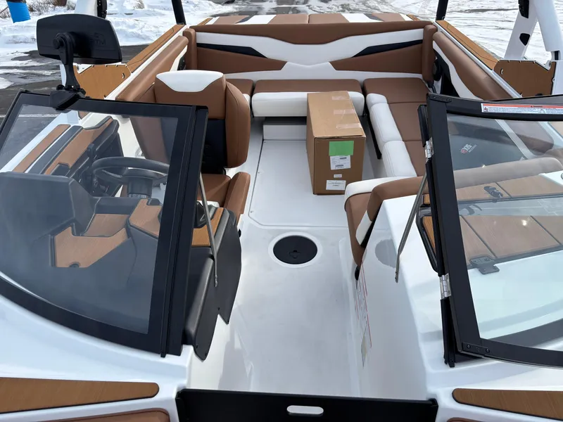 Slide: The Image of 2025 Axis T220 boat interior with tan seating and modern dashboard design. - 4