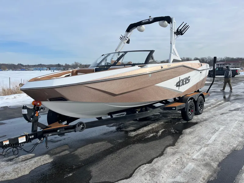 Slide: The Image of 2025 Axis T220 boat on trailer, parked on snowy pavement near a lake. - 5