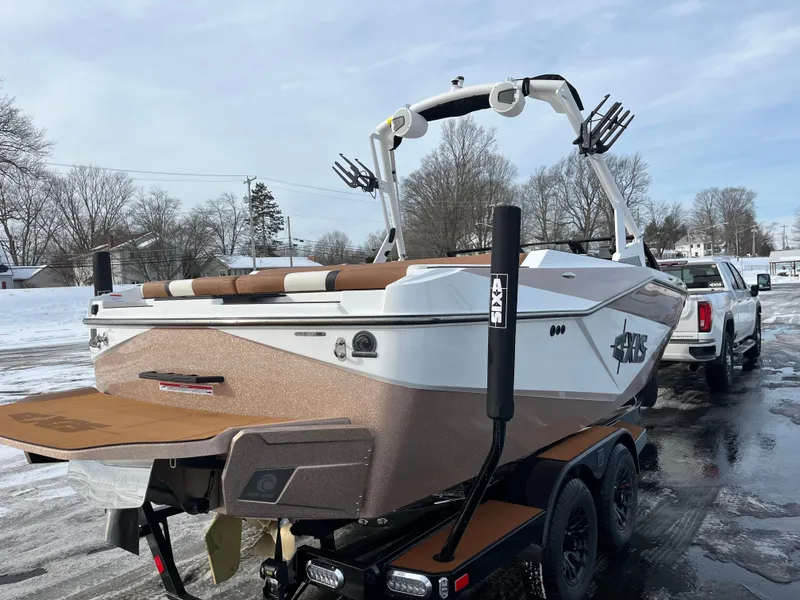 Slide: The Image of 2025 Axis T220 boat on trailer in snowy setting, rear view. - 8