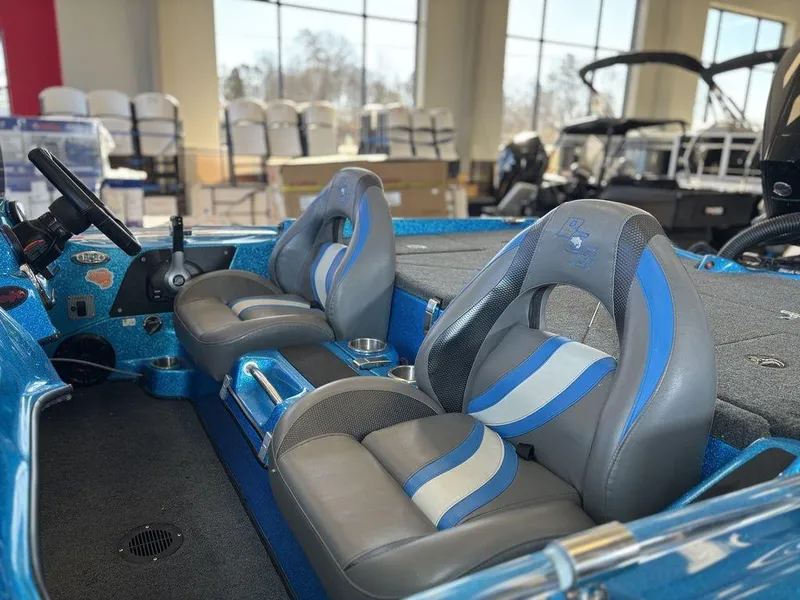 Slide: The Image of 2020 Bass Cat Puma FTD boat interior with blue and gray seats, steering wheel, and spacious layout. - 11