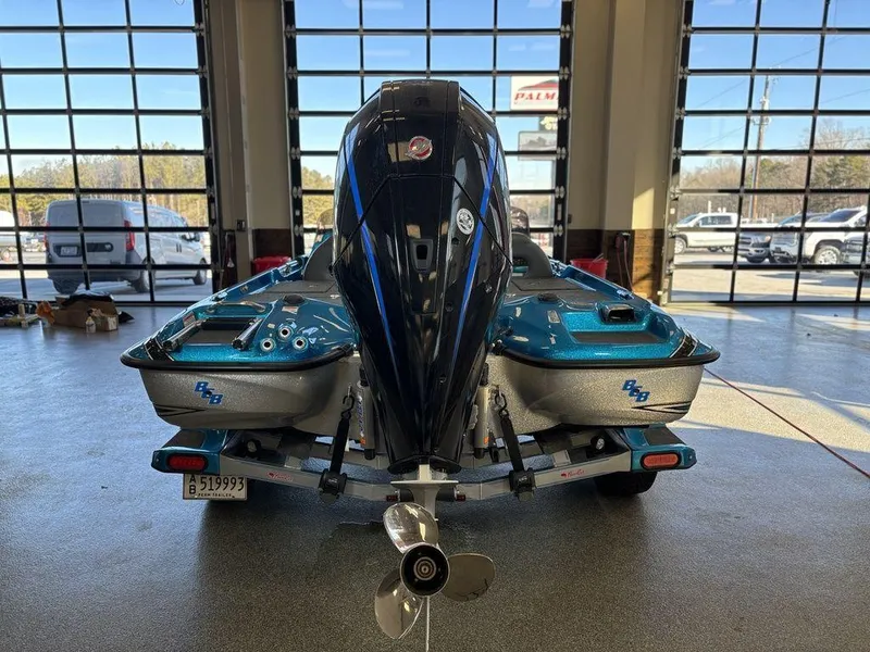 Slide: The Image of 2020 Bass Cat Puma FTD boat in showroom, rear view with motor and trailer. - 12