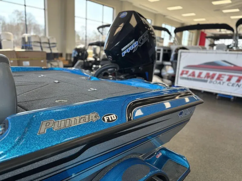 Slide: The Image of 2020 Bass Cat Puma FTD boat in showroom, blue finish, Palmetto Boat Center sign. - 3