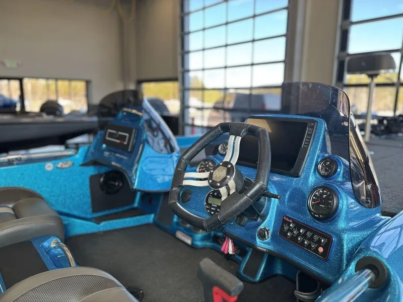 Slide: The Image of 2020 Bass Cat Puma FTD boat interior with blue dashboard and steering wheel. - 4