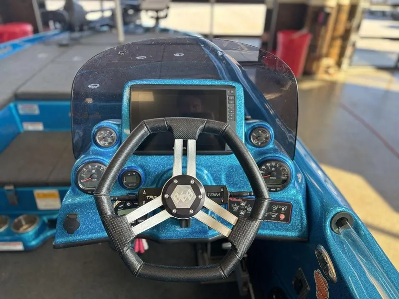 Slide: The Image of 2020 Bass Cat Puma FTD boat dashboard with steering wheel and control panel. - 6