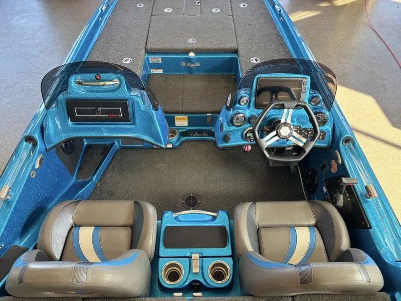 Slide: The Image of 2020 Bass Cat Puma FTD boat interior with blue and gray seating and dashboard. - 7