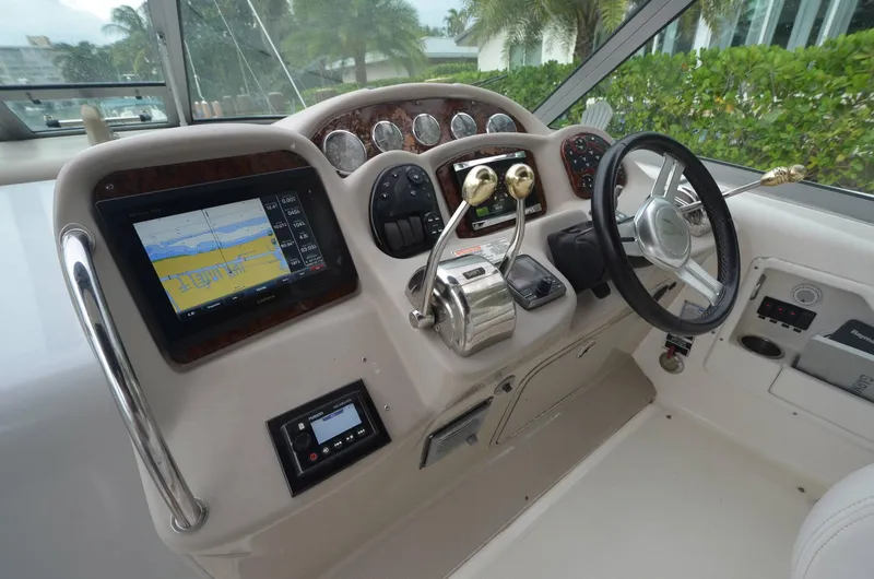 Slide: The Image of 2007 Sea Ray 340 Sundancer helm with navigation display and steering wheel. - 14