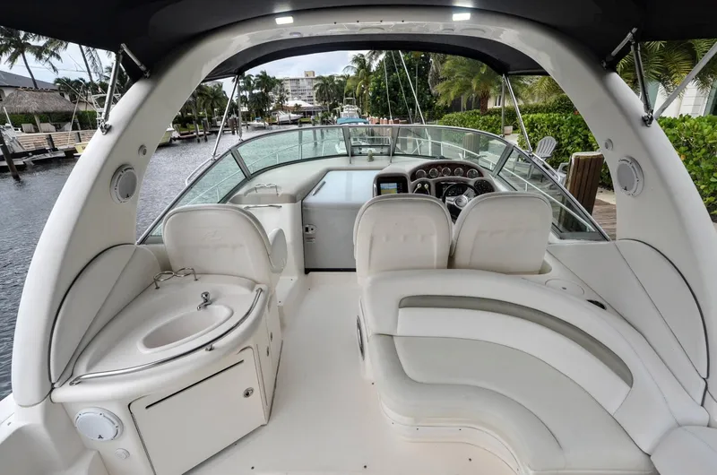 Slide: The Image of 2007 Sea Ray 340 Sundancer boat interior with white seating and helm station. - 25