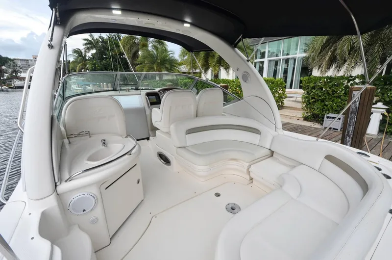 Slide: The Image of 2007 Sea Ray 340 Sundancer boat interior with white seating and helm. - 26