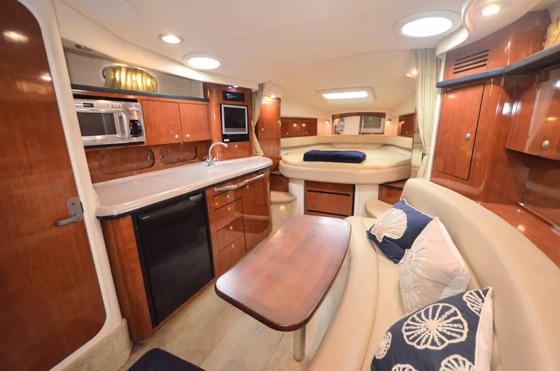 Slide: The Image of Interior of a 2007 Sea Ray 340 Sundancer yacht, featuring a cozy kitchen and seating area. - 3