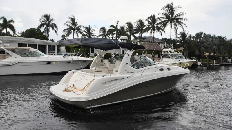 Slide: The Image of 2007 Sea Ray 340 Sundancer yacht cruising on a tropical waterway with palm trees. - 32