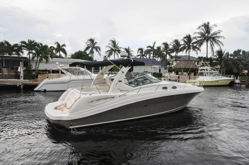 Slide: The Image of 2007 Sea Ray 340 Sundancer yacht docked in a tropical marina setting. - 33