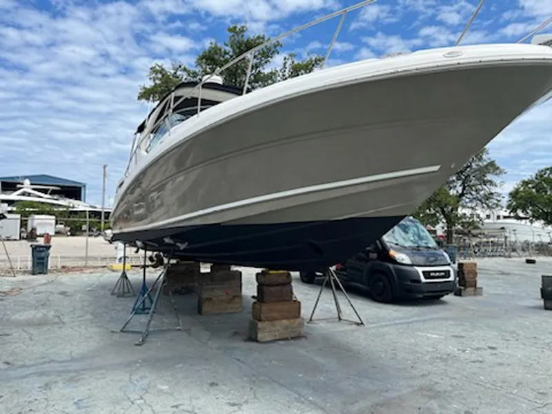 Slide: The Image of 2007 Sea Ray 340 Sundancer boat on dry dock, clear sky background. - 36