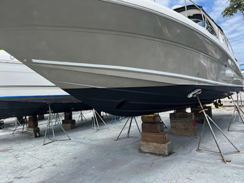 Slide: The Image of 2007 Sea Ray 340 Sundancer boat on stands, viewed from below, in a dry dock setting. - 37