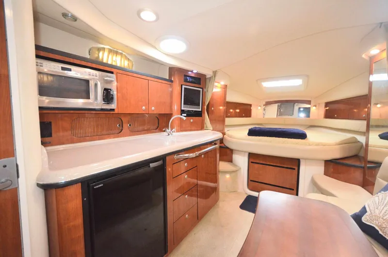 Slide: The Image of Interior of 2007 Sea Ray 340 Sundancer yacht with kitchen and seating area. - 4