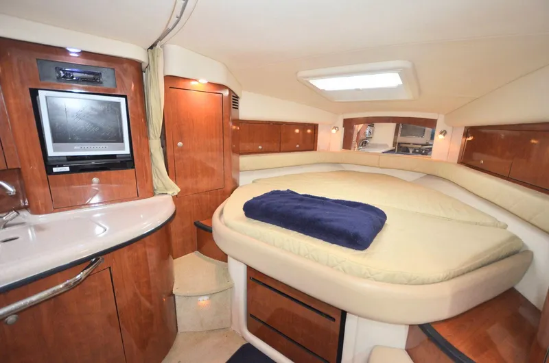 Slide: The Image of 2007 Sea Ray 340 Sundancer cabin interior with bed, TV, and wood cabinetry. - 5