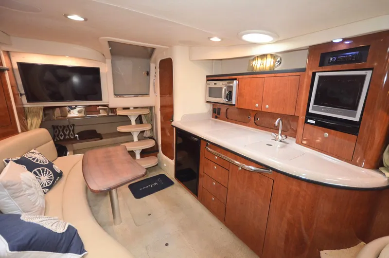Slide: The Image of Interior of 2007 Sea Ray 340 Sundancer yacht with modern kitchen and seating area. - 7