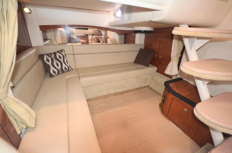 Slide: The Image of Interior of 2007 Sea Ray 340 Sundancer, featuring beige seating and wooden accents. - 8
