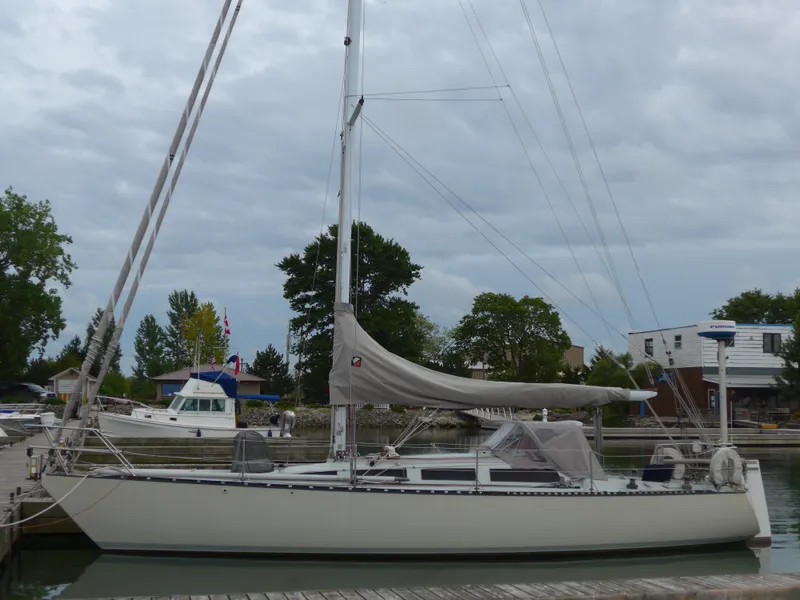 Slide: The Image of 1986 Abbott 36 sailboat docked at a marina under cloudy skies. - 1