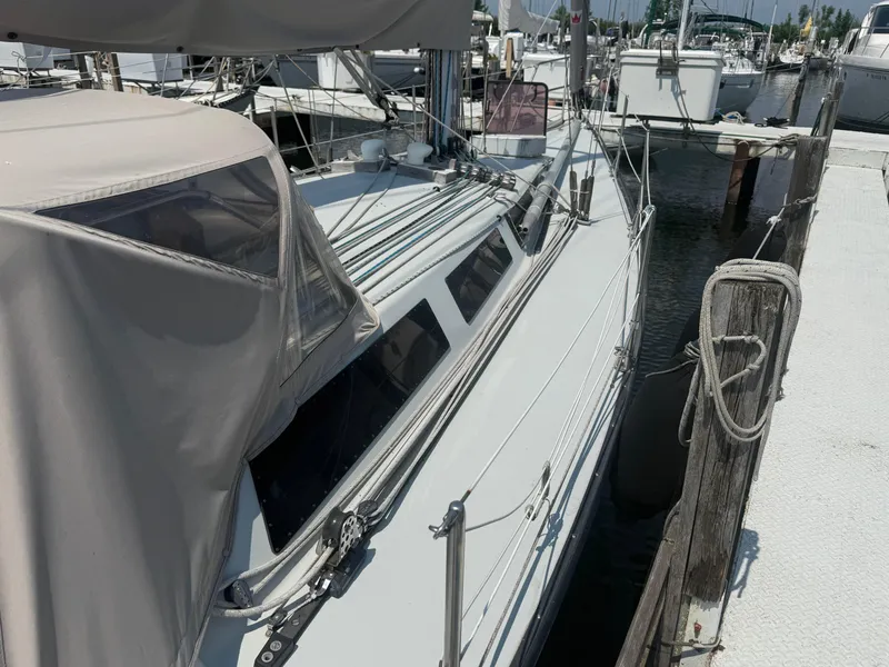 Slide: The Image of Sailboat docked at marina, Abbott 36 model, 1986, with covered cockpit and rigging. - 14