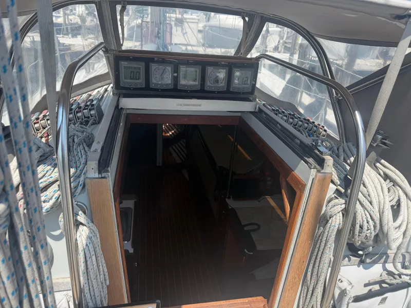 Slide: The Image of Cockpit view of 1986 Abbott 36 sailboat with navigation instruments and ropes. - 17