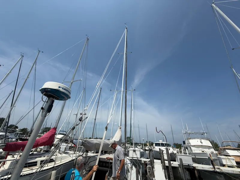 Slide: The Image of Sailboats docked at marina under clear blue sky, featuring Abbott 36, 1986 model. - 18