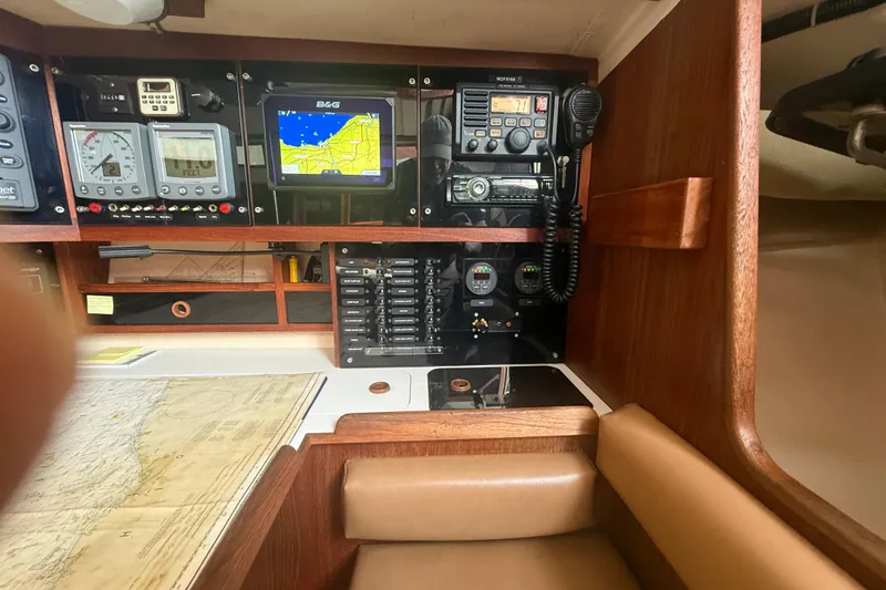 Slide: The Image of Navigation station on 1986 Abbott 36 sailboat with instruments and chart. - 26