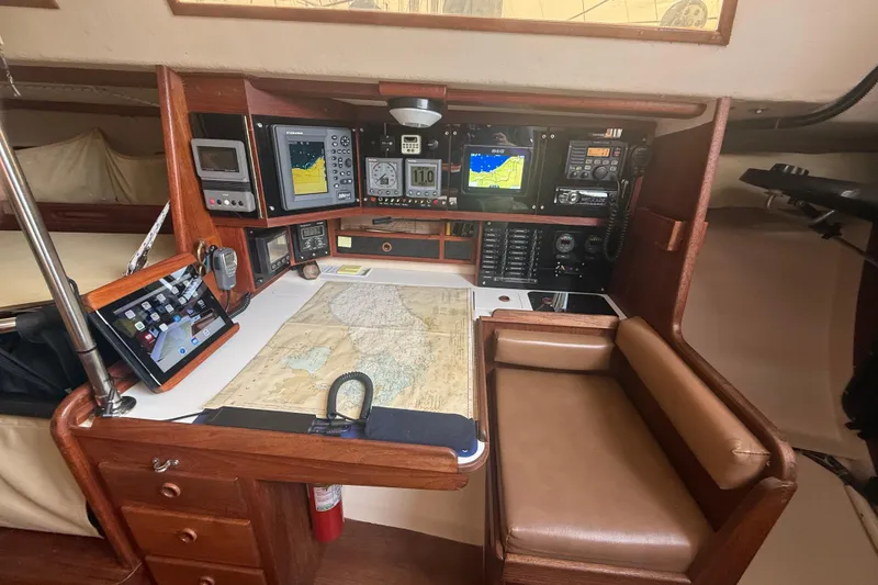 Slide: The Image of Navigation station on 1986 Abbott 36 sailboat with maps, electronics, and seating. - 27