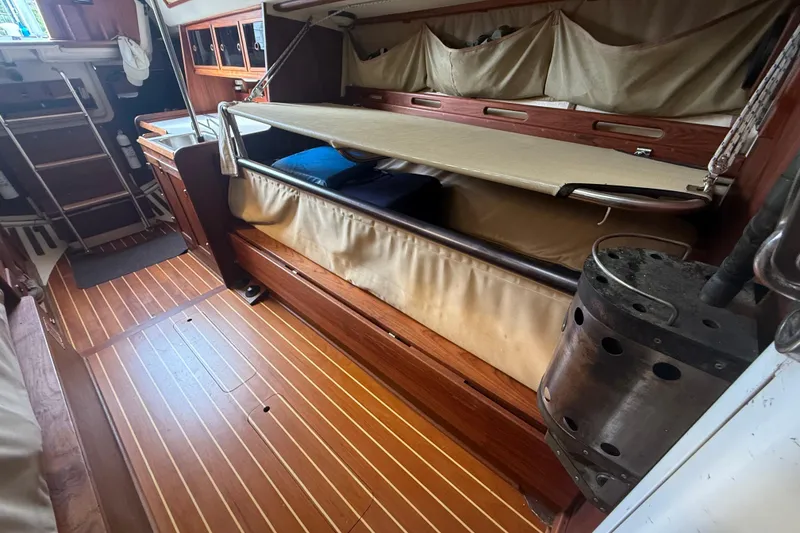 Slide: The Image of Interior of a 1986 Abbott 36 sailboat with wooden flooring and foldable bunk. - 29