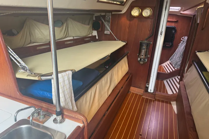 Slide: The Image of Interior of 1986 Abbott 36 sailboat with wooden finish and cozy sleeping area. - 30