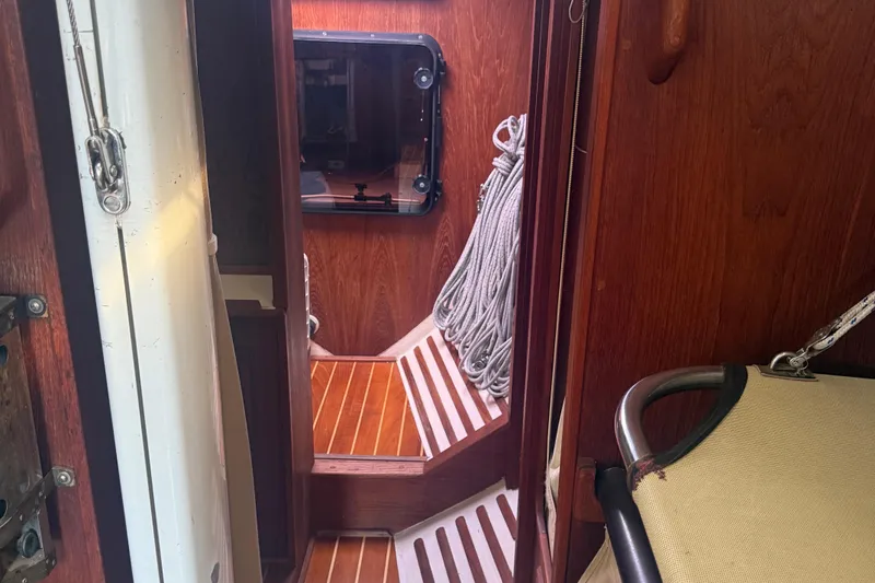 Slide: The Image of Interior of 1986 Abbott 36 sailboat with wooden flooring and coiled ropes. - 31